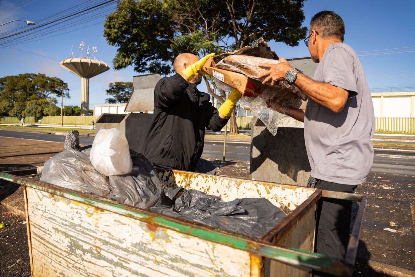 Clear Path Solutions crew loading a dumpster